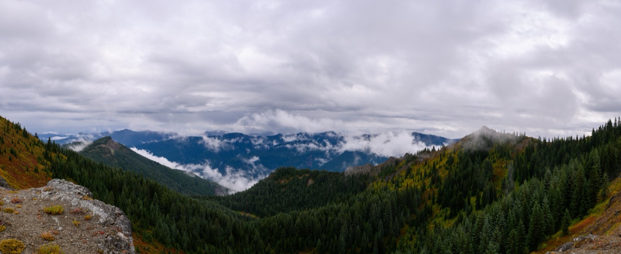 Misty mountain ridgelines and fall color, seen from a high trail